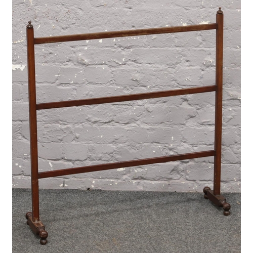 575 - A slender mahogany towel rail.