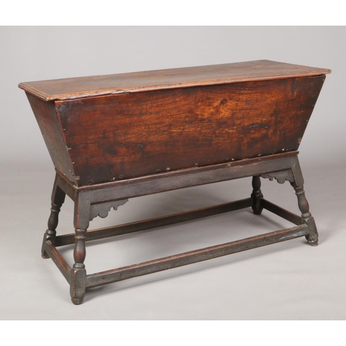 577 - An 18th century elm dough bin. With moulded rectangular lift off top and raised on an oak stand with... 