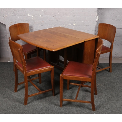 732 - A drop leaf dining table and set of four chairs, along with a Lloyd Loom chair.