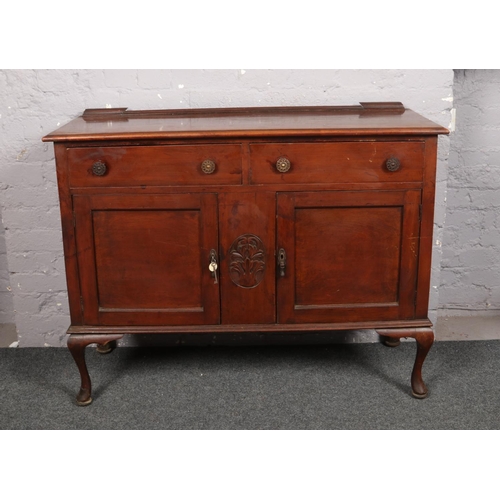 735 - A Victorian carved mahogany sideboard, raised on cabriole supports.