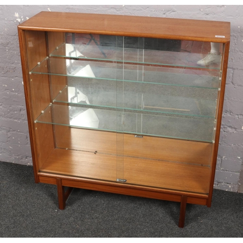 742 - A Turnidge teak display cabinet with glass sliding doors.