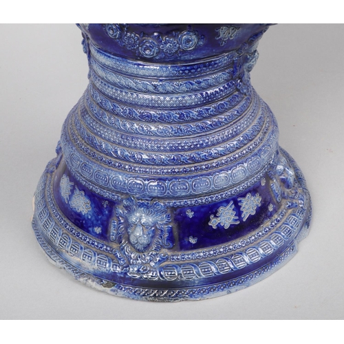 149 - An early 20th century very large German Westerwald stoneware floor ewer. Blue glazed and moulded wit... 