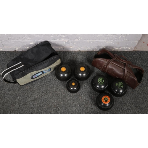 253 - Two carry cases of lawn bowls to include set of J.D.S bowls and two Taylor Lignoid examples etc.