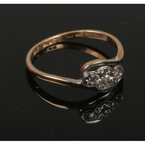 420 - A 9ct gold and platinum three stone diamond ring. c.1950, size R.