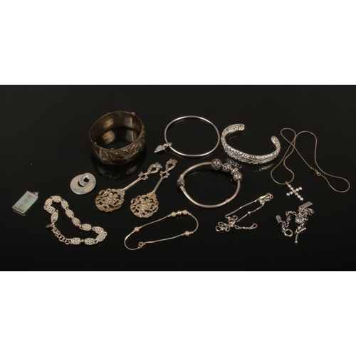 444 - A collection of silver, mainly jewellery. Including bangles, pierced decorative spoons, bracelets an... 