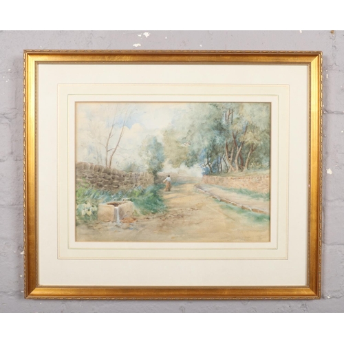 332 - A framed watercolour, country road landscape scene with a female figure, signed indistinct. (26cm x ... 