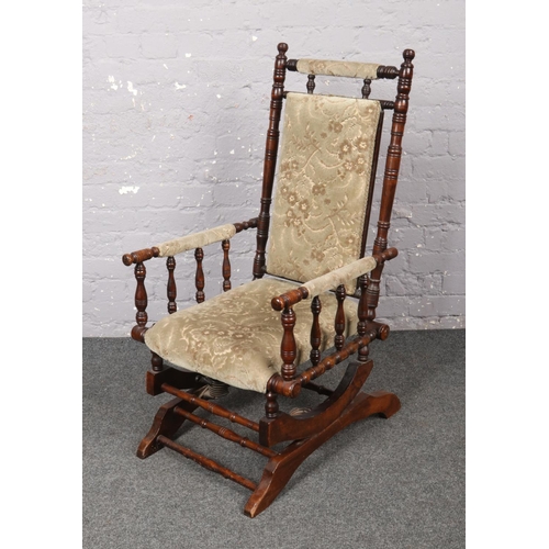 642 - A mahogany American rocking chair.