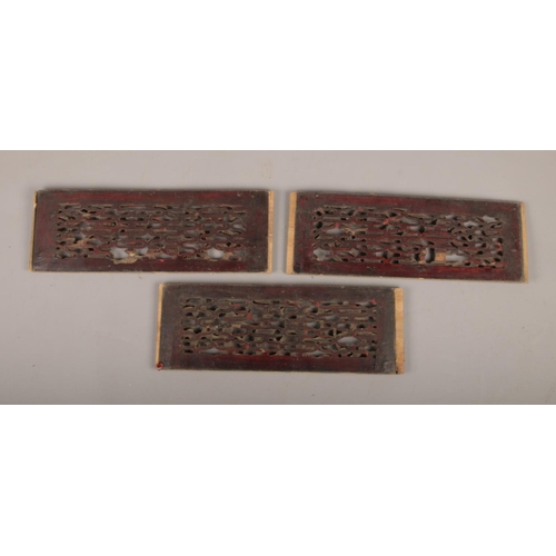 203 - A set of three mid 19th century carved wooden panels, with double sided carving.