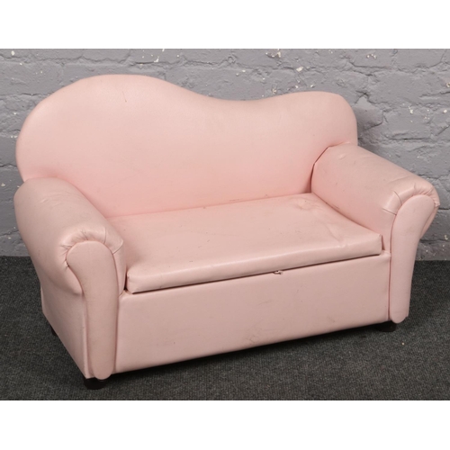 645 - A miniature pink leatherette child's settee, 83cm wide.