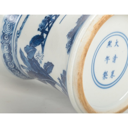 488 - A Chinese blue and white gu shaped vase. Painted in underglaze blue with figures in an outdoor setti... 