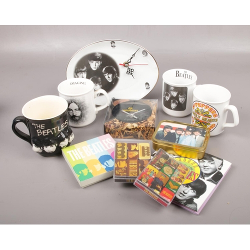 494 - A box of The Beatles collectables, to include mugs, magnets, clocks etc.