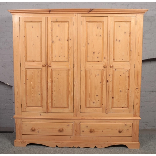 633 - A pine triple wardrobe.