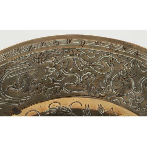 137 - A pair of 20th century Chinese bronze chargers. One chased with a dragon and the other a phoenix, 40... 