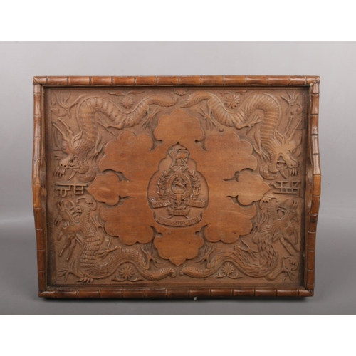 167 - An Anglo-Chinese wooden tray, carved with dragons, and bamboo, bearing the Victorian badge of the 5t... 