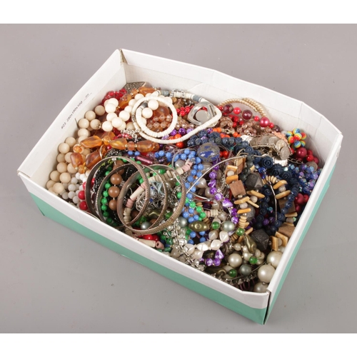 106 - A box of costume jewellery, to include beads, bangles, coin bracelet etc.