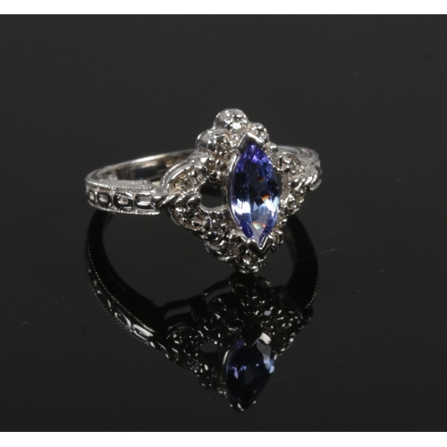 403 - A 14ct white gold marquis tanzanite and diamond ring. Size O.