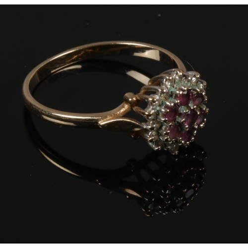 442 - A 9ct gold ruby and diamond cluster ring, size P.