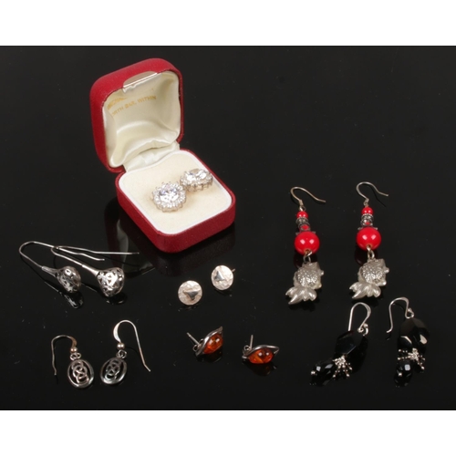 477 - Seven pairs of silver earrings including a pair of moissanite cluster ear studs.