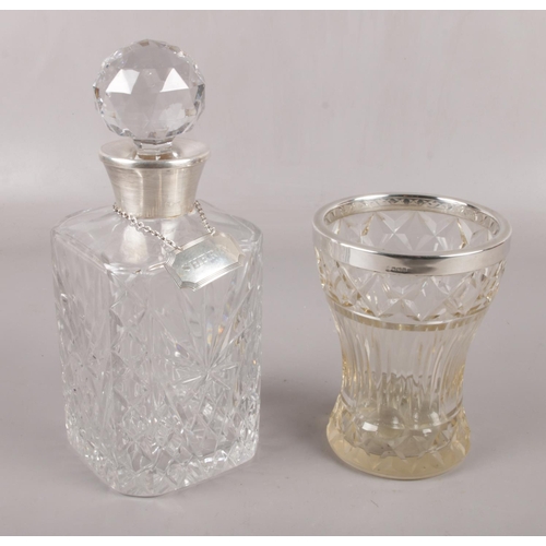 540 - A cut glass decanter with silver collar, and silver sherry label, along with a silver rimmed glass v... 