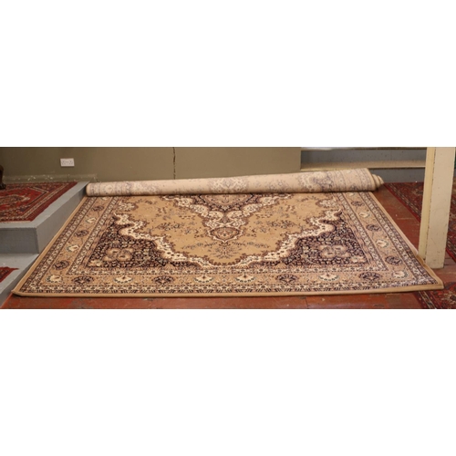 611 - A large faun ground wool carpet with central medallion design. (400cm x 300cm).