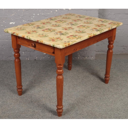 646 - A pine kitchen table with cutlery drawer. 76cm x 107cm.