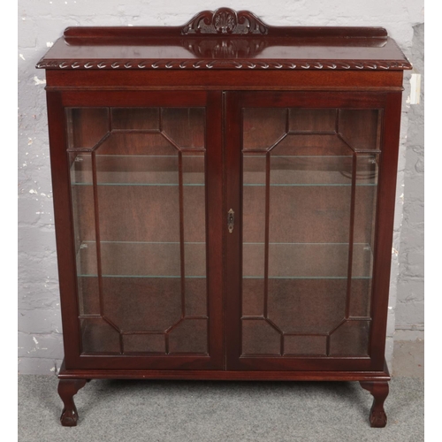 649 - A astragal glazed mahogany display cabinet with carved gallery, raised on ball and ball feet.