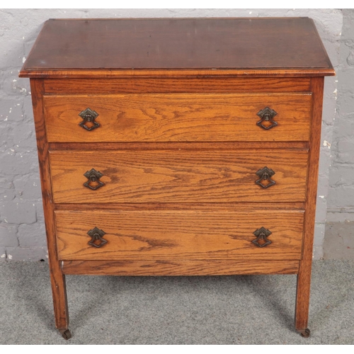 654 - An oak three drawer chest.