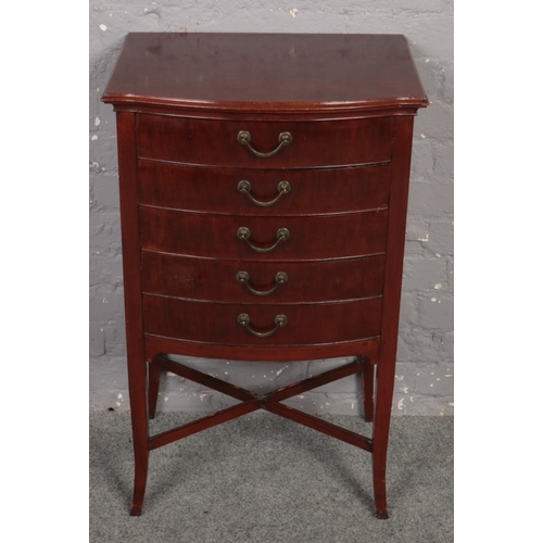 661 - A mahogany bow front music cabinet with x frame support. (89cm x 54cm)