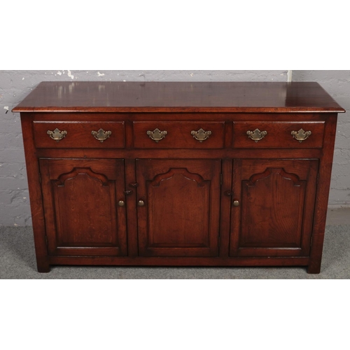 669 - An oak Titchmarsh & Goodwin style sideboard. (90cm x 134cm)