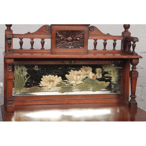 670 - A Victorian mahogany music cabinet. With mirror back painted with water lilies, astragal glazed door... 