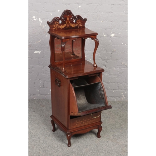 671 - An Edwardian mahogany coal perdonium. With carved scroll pediment, mirrored back, having marquetry i... 