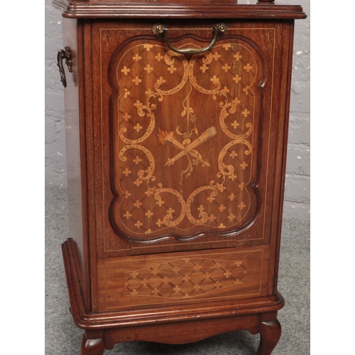 671 - An Edwardian mahogany coal perdonium. With carved scroll pediment, mirrored back, having marquetry i... 