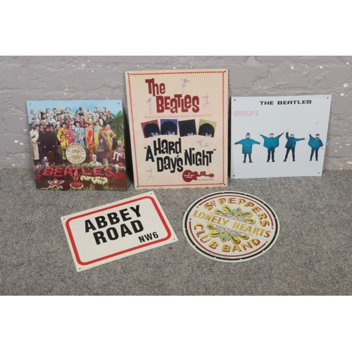 374 - Five metal signs 'The Beatles A Hard Days Night', St. Peppers Lonely Hearts Club band examples