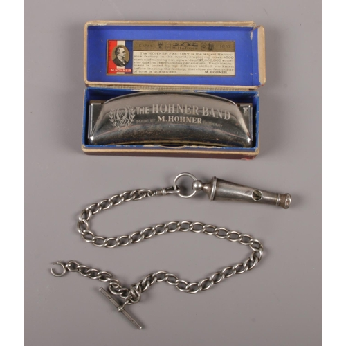 455 - A Victorian silver whistle on single Albert chain by Hilliard & Thomason, assayed Birmingham 1887. A... 