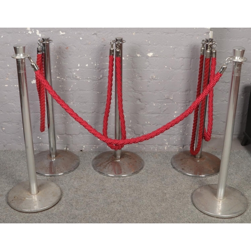 616 - Two sets of chrome and red rope stanchion barriers.