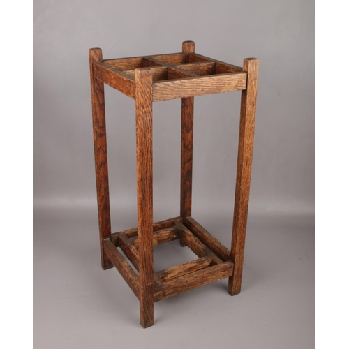 100 - An Arts & Crafts oak stick stand, 61cm high.