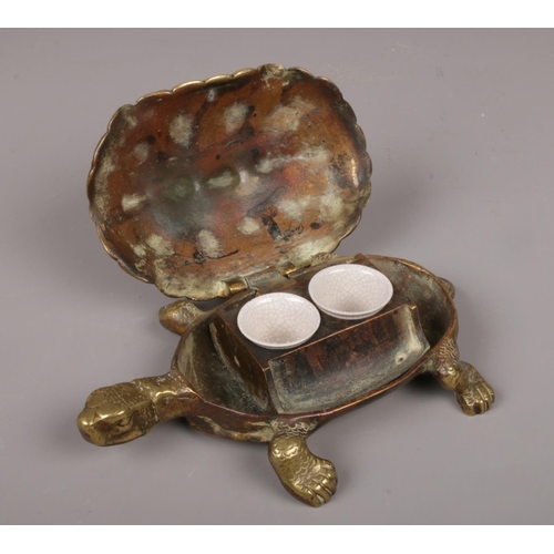 98 - A Victorian novelty cast brass inkwell modelled as a tortoise, the hinged brass carapace opening to ... 