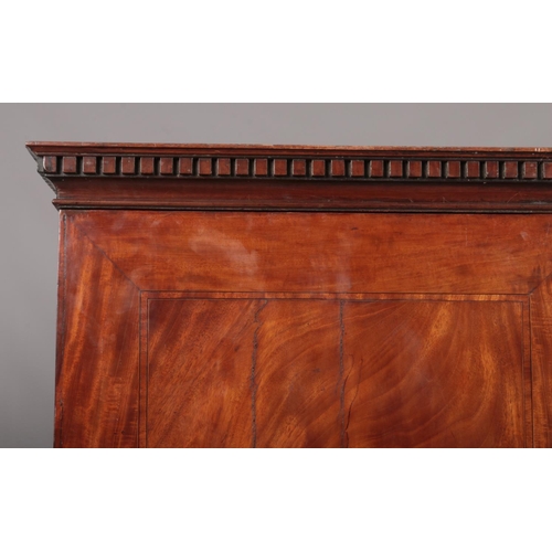 275 - A George III figured mahogany cottage linen press raised on a three drawer base. With oak carcass, d... 