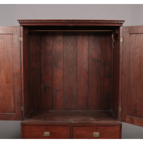 275 - A George III figured mahogany cottage linen press raised on a three drawer base. With oak carcass, d... 