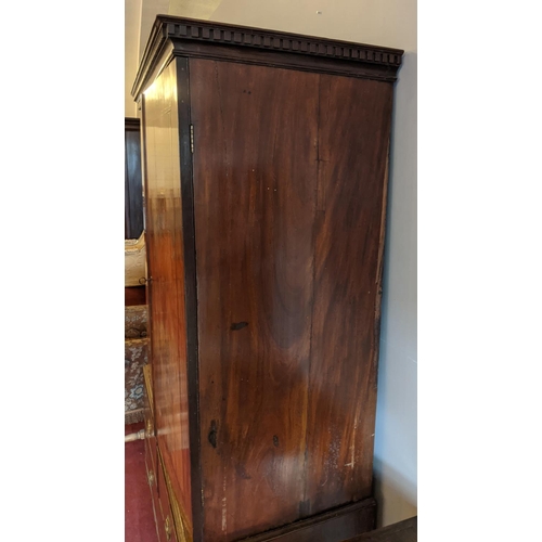 275 - A George III figured mahogany cottage linen press raised on a three drawer base. With oak carcass, d... 