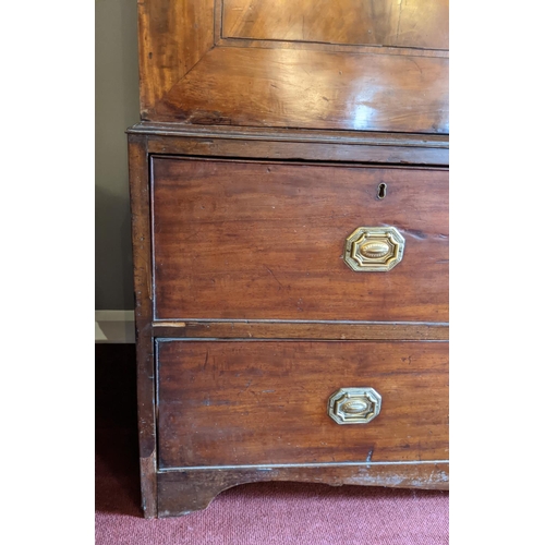 275 - A George III figured mahogany cottage linen press raised on a three drawer base. With oak carcass, d... 