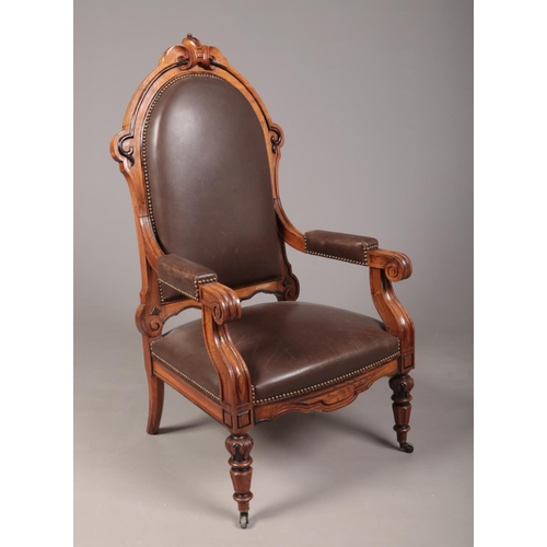 267 - A Biedermeier carved rosewood library chair with ebonized mouldings. Leather upholstered, with reede... 