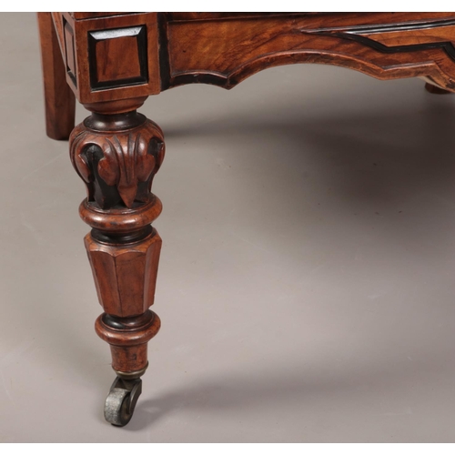 267 - A Biedermeier carved rosewood library chair with ebonized mouldings. Leather upholstered, with reede... 