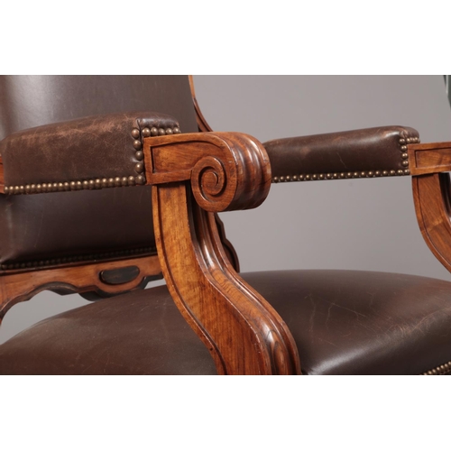 267 - A Biedermeier carved rosewood library chair with ebonized mouldings. Leather upholstered, with reede... 