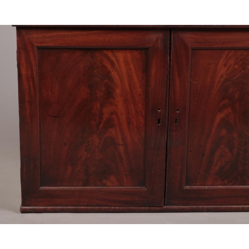 268 - A Regency mahogany dwarf bookcase on cupboard base, 150cm height 103cm width 42cm depth.