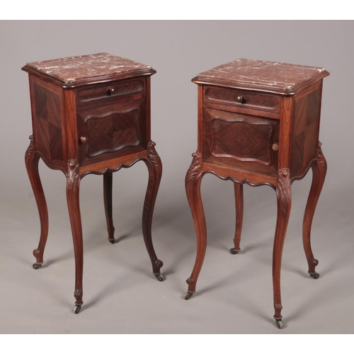 277 - A pair of early 20th century French kingwood and rosewood marble top pot cupboards. Each with a sing... 