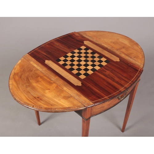 288 - A George III satinwood Pembroke games table. Crossbanded in mahogany, with strung inlay and raised o... 