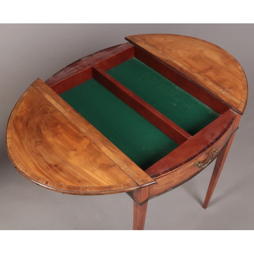 288 - A George III satinwood Pembroke games table. Crossbanded in mahogany, with strung inlay and raised o... 