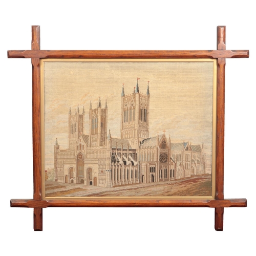 250 - A Victorian woolwork embroidery in chamfered oak frame with gilt fillet. View of Lincoln Cathedral, ... 