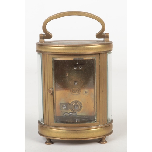 64 - A 19th century oval brass carriage clock retailed by J. Shaw & Son, Manchester. With enamel dial and... 